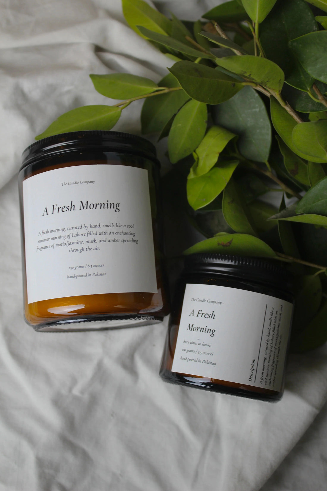 A Fresh Morning soy candle in an amber jar by The Candle Company, burning evenly to prevent candle tunnelling