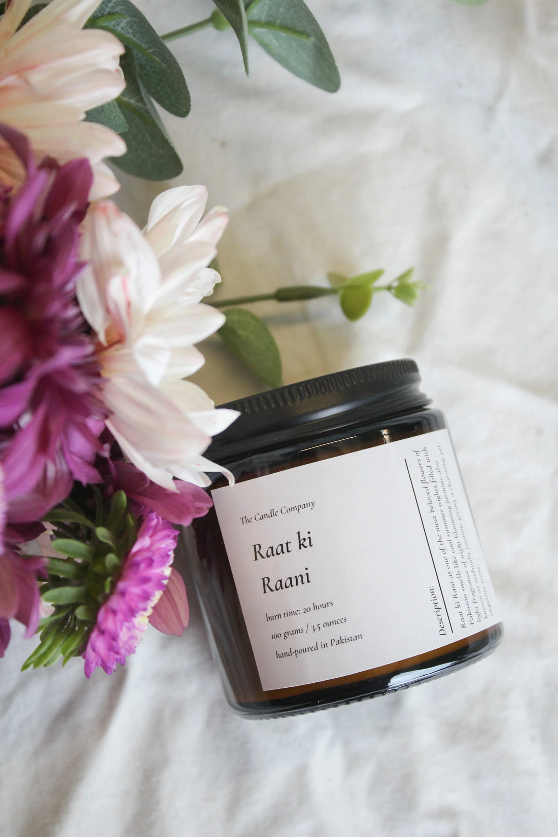Raat Ki Rani scented soy candle in an amber jar by The Candle Company