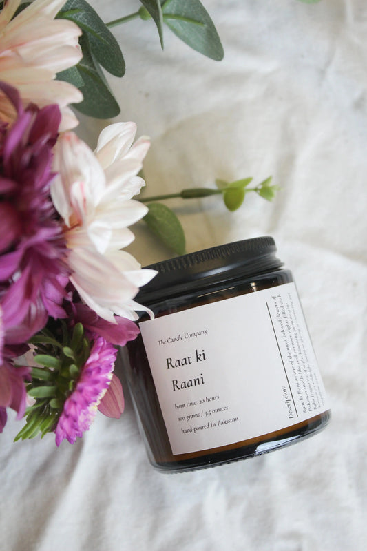 Raat Ki Rani scented soy candle in an amber jar by The Candle Company
